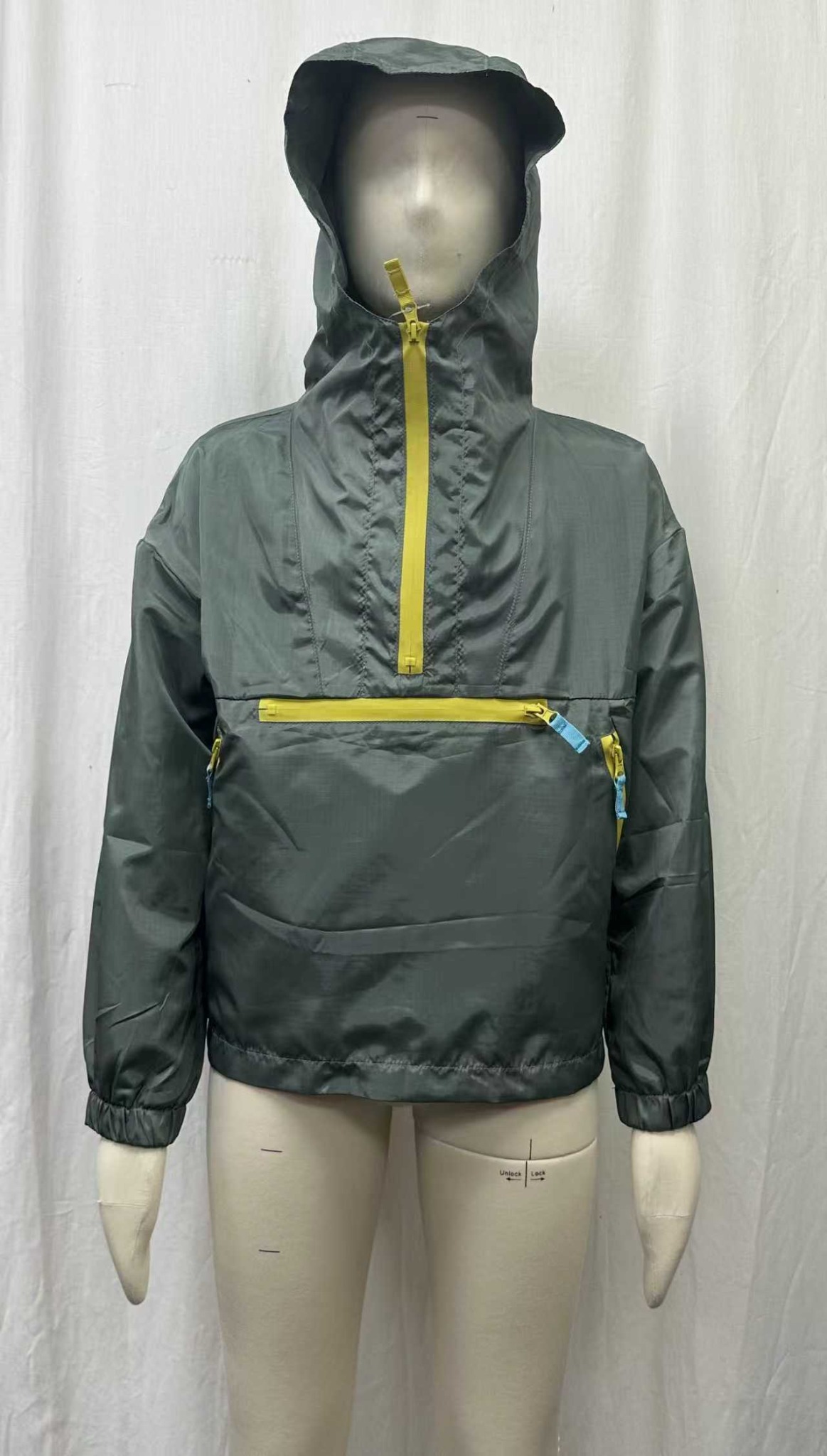 A hooded outerwear sample with contrasting zips and a front pocket.