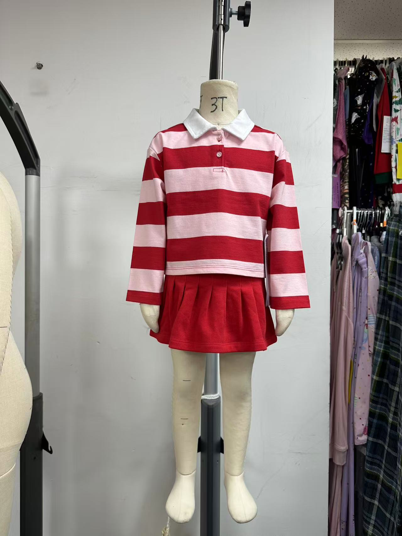 A coordinated striped collared top and pleated skirt.