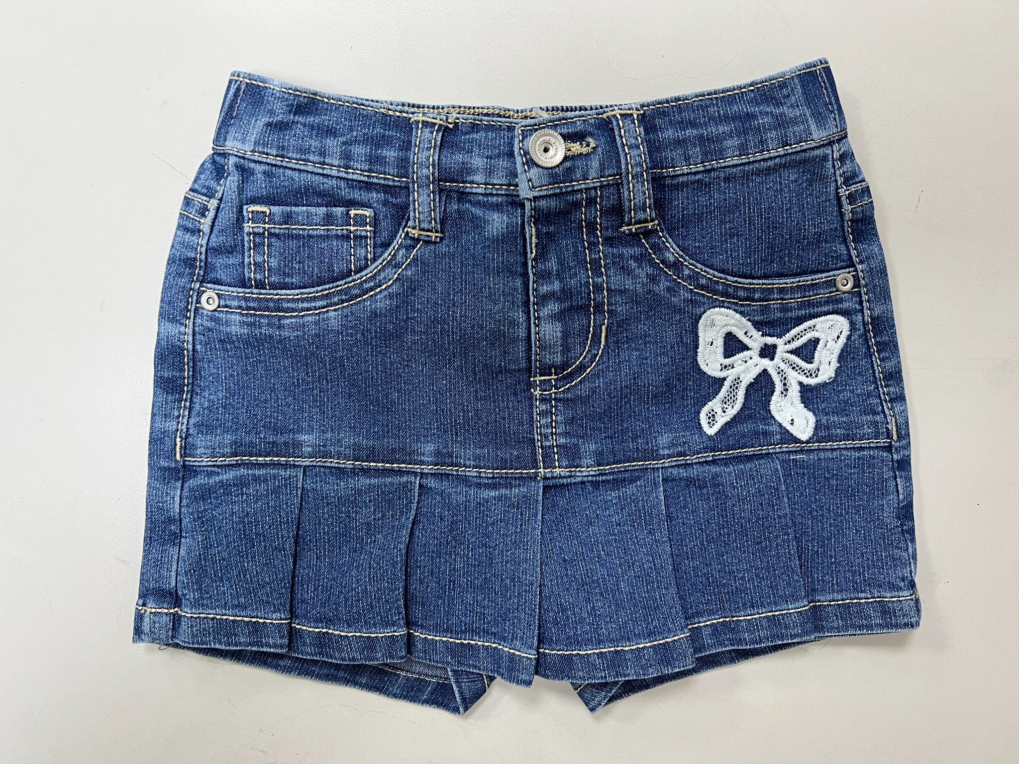 Denim shorts sample with a white bow detail